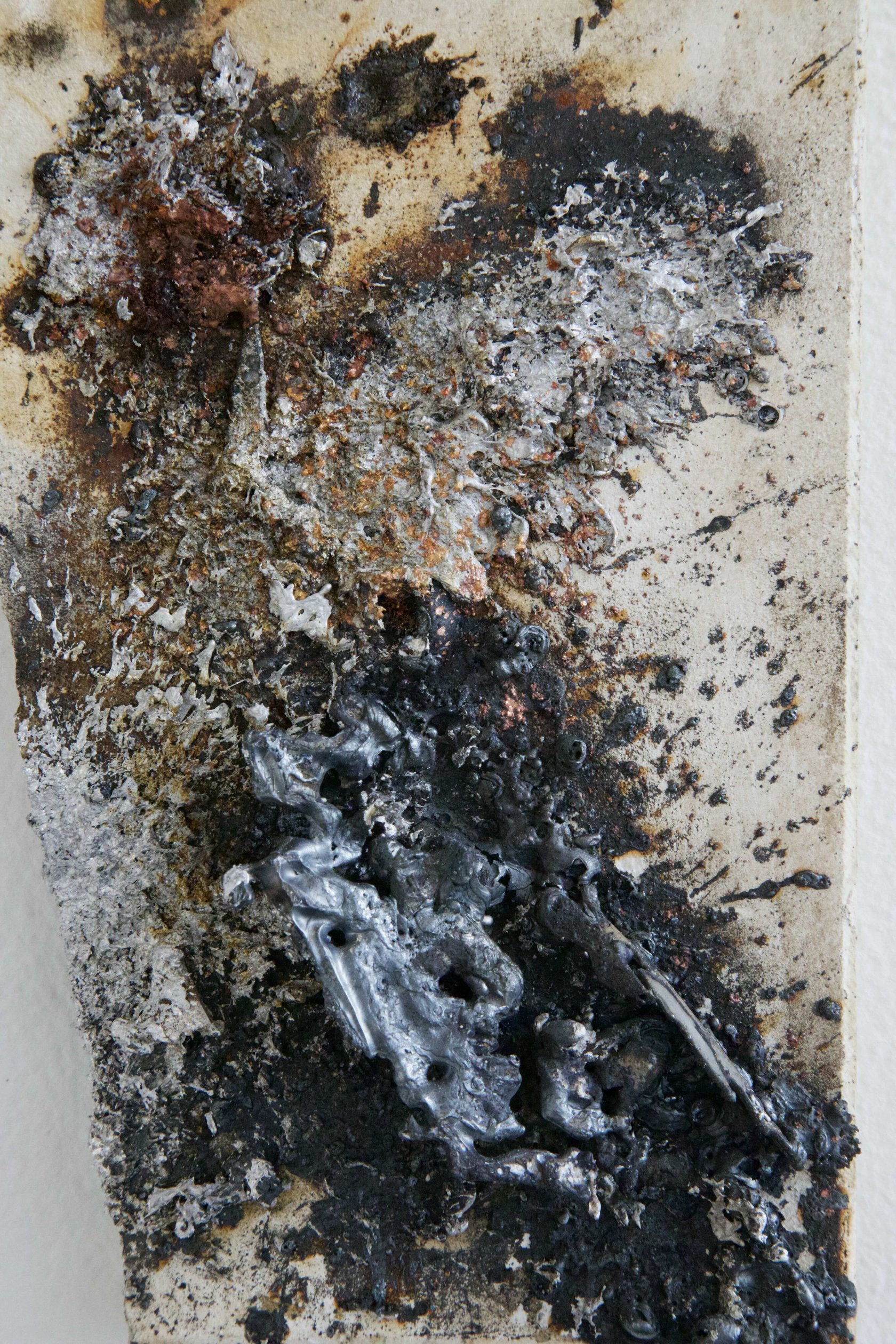 Detail of sprayed metal texture on mineral tile