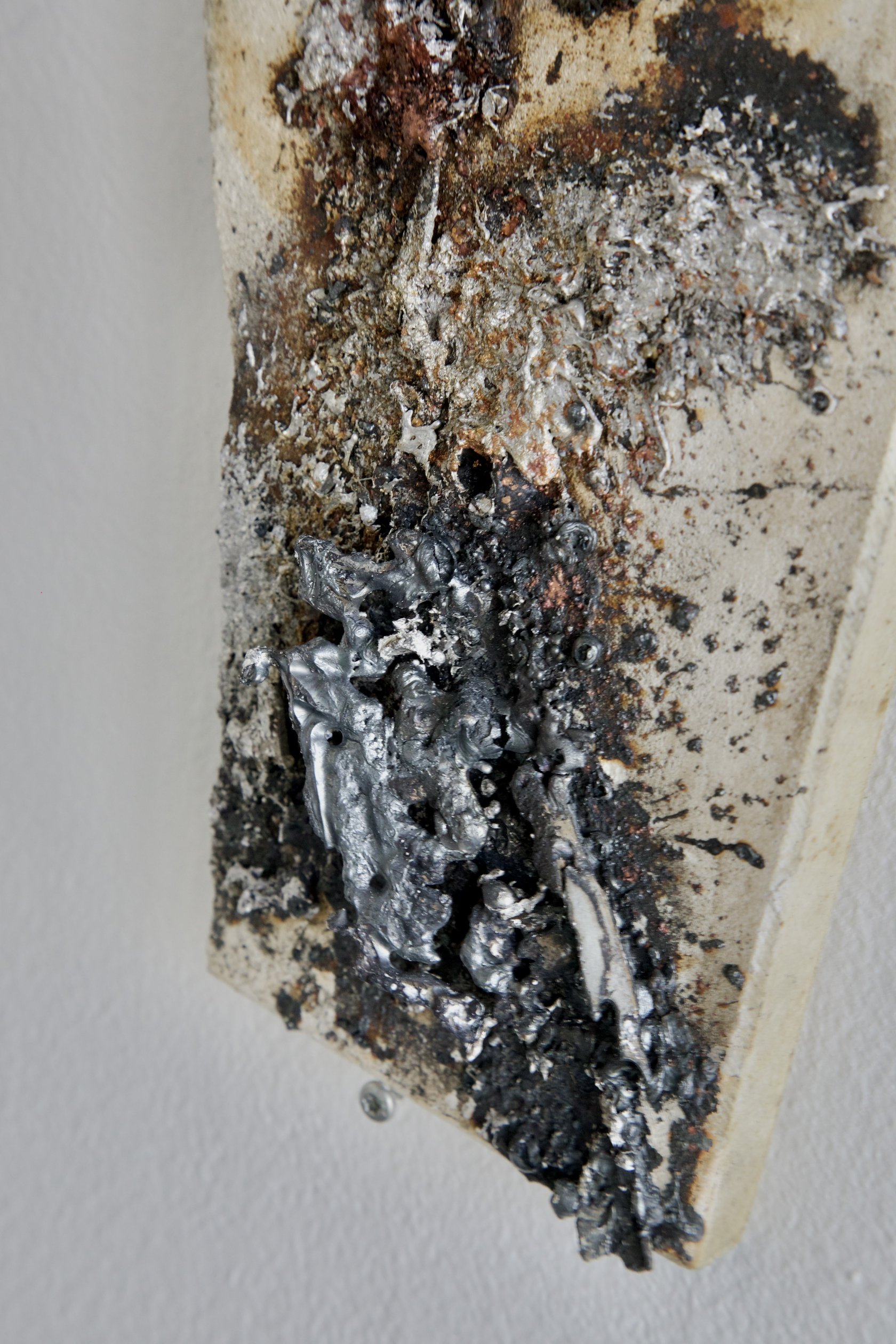 Detail of sprayed metal texture on mineral tile