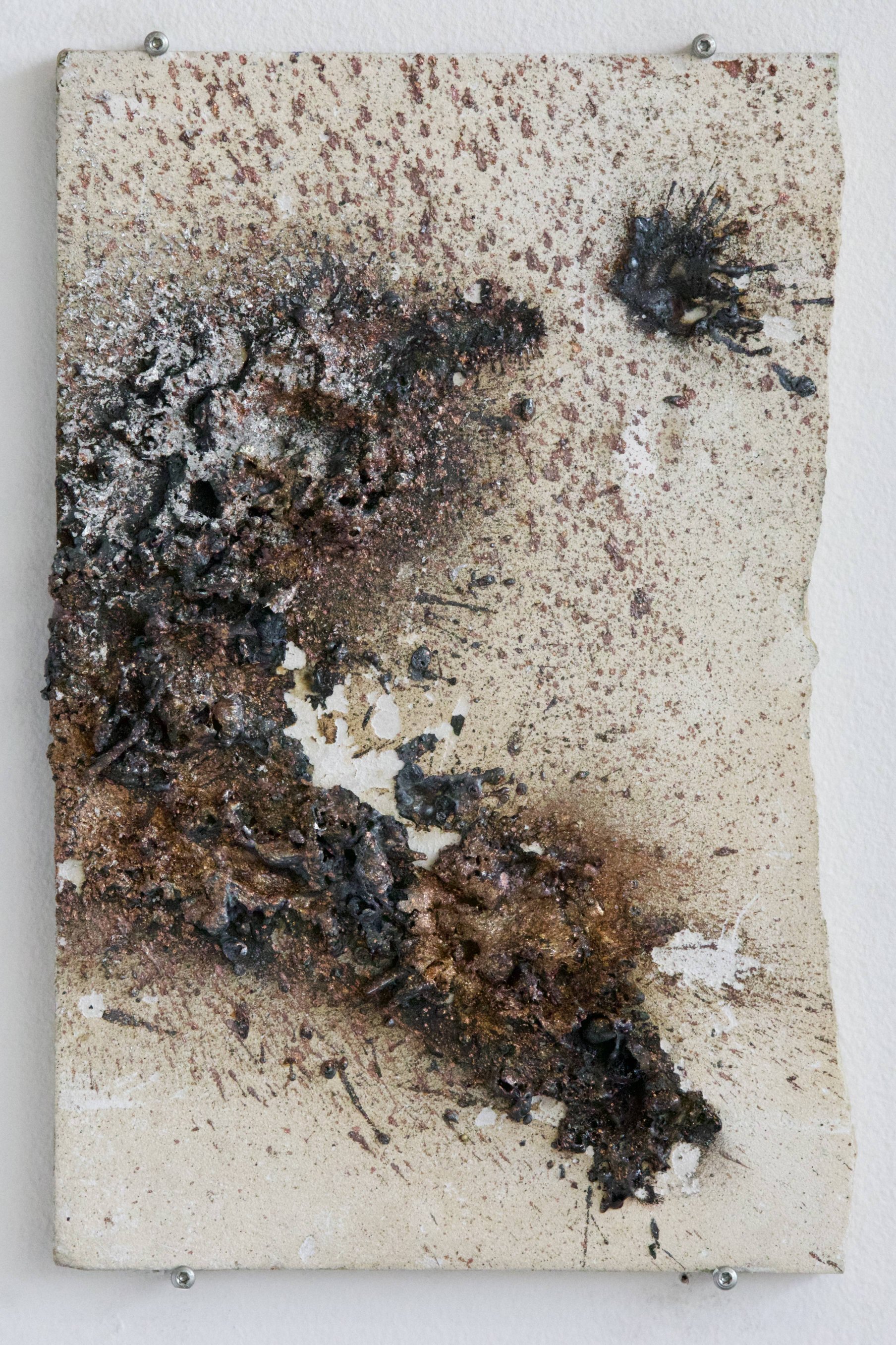 Mineral tile panel with reddish speckled surface and two sprayed metal deposits, bolted wall mount
