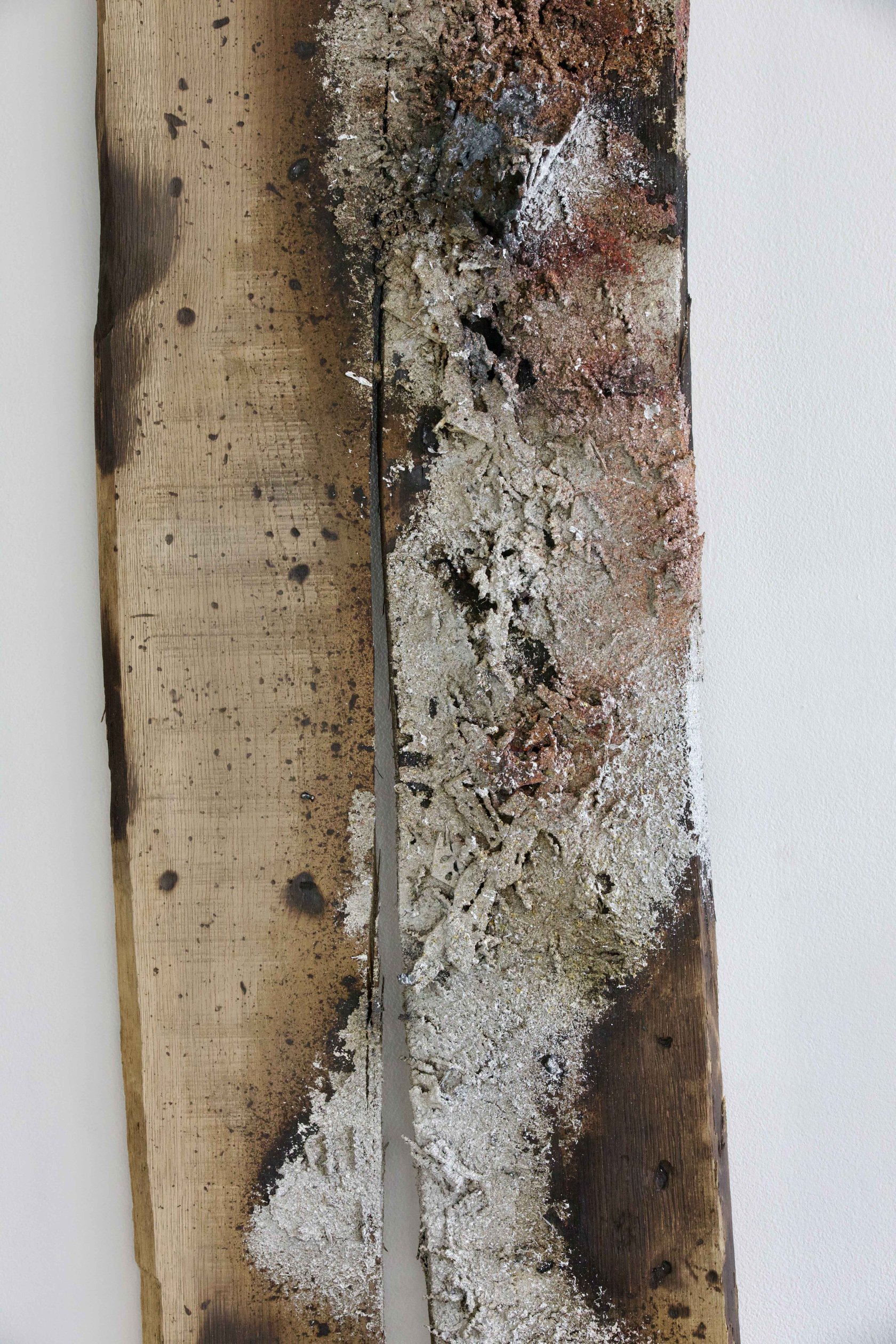 Detail of scorched oak grain and metal residue in Sprawl