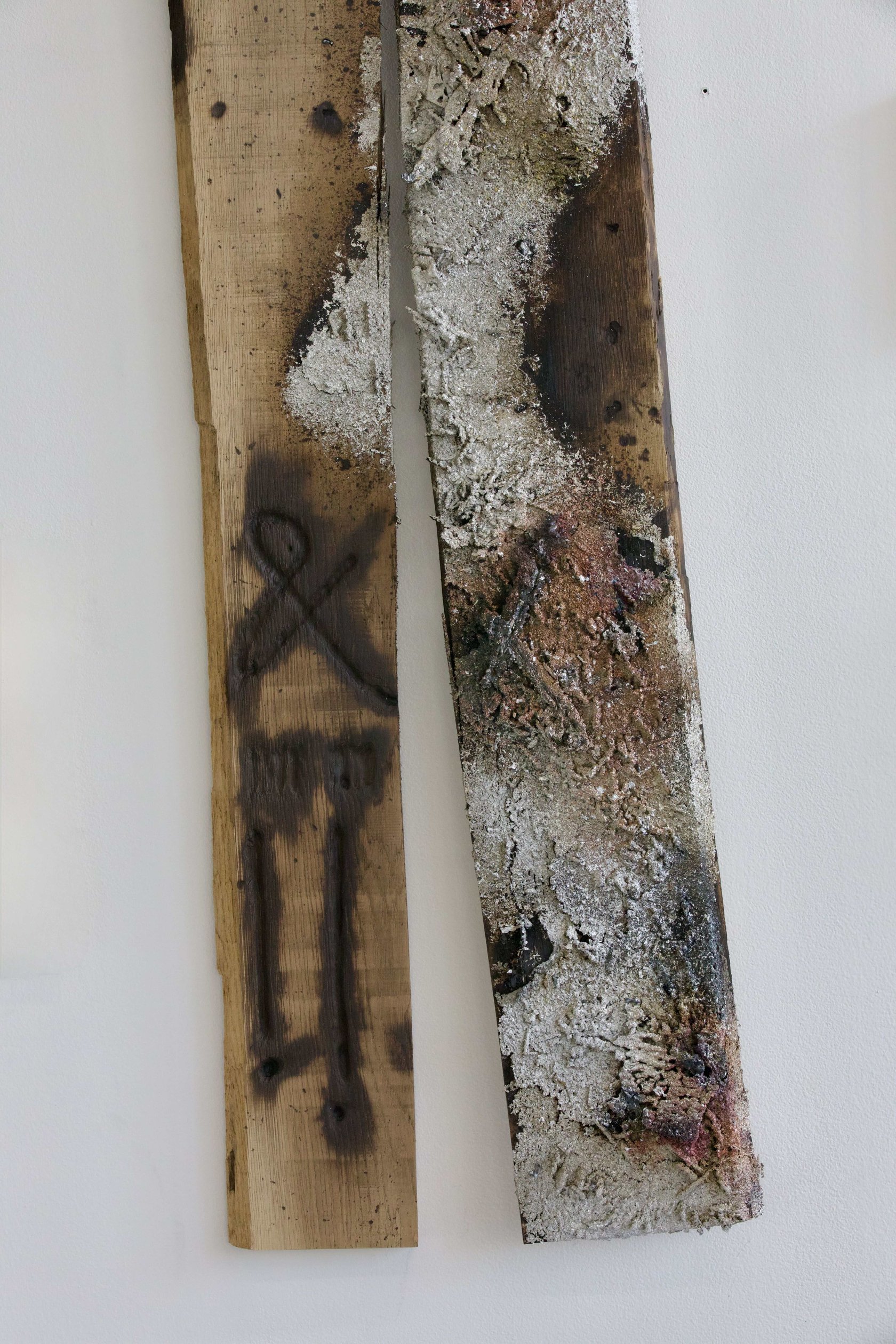 Detail of scorched oak grain and metal residue in Sprawl
