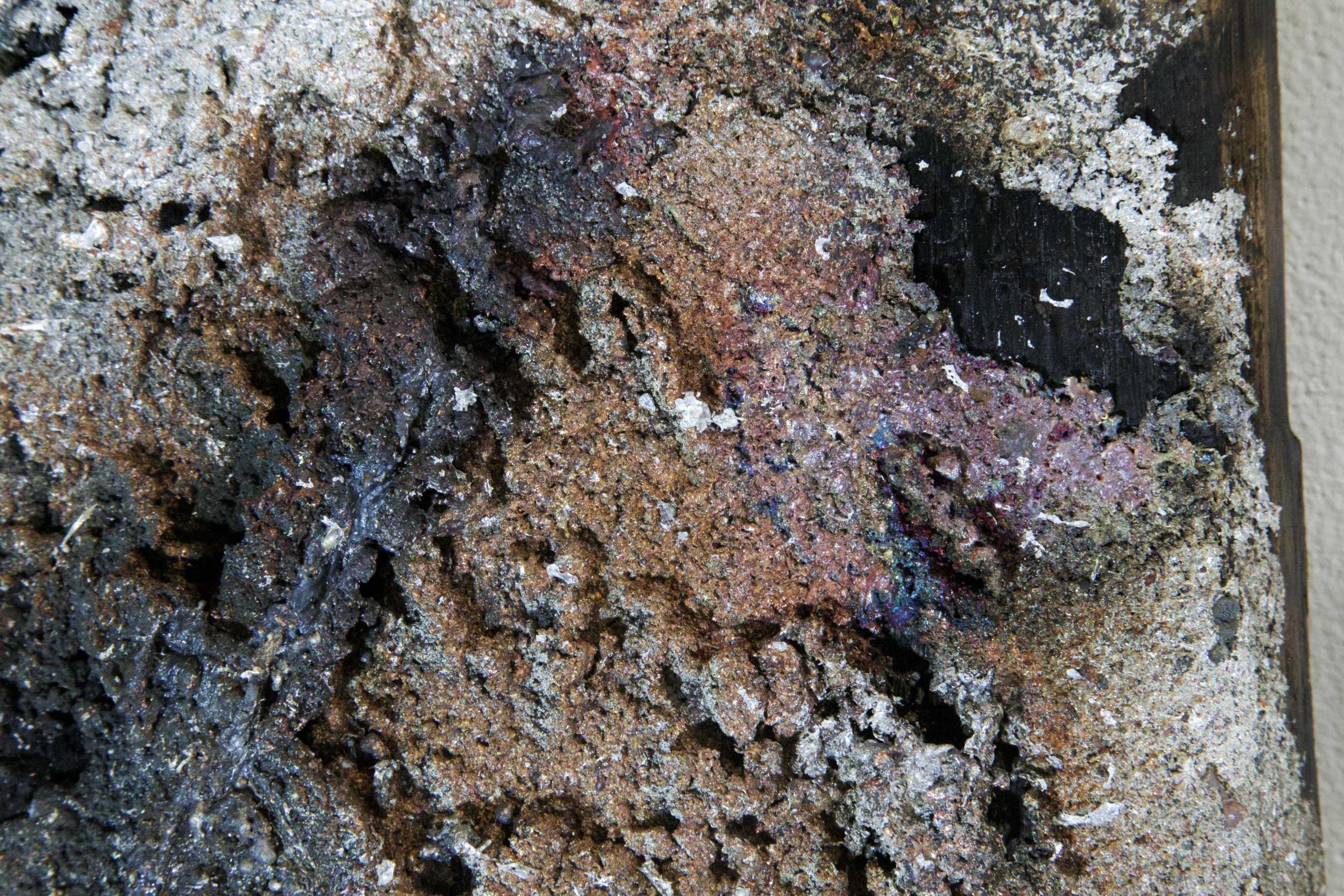 Detail of scorched oak grain and metal residue in Sprawl