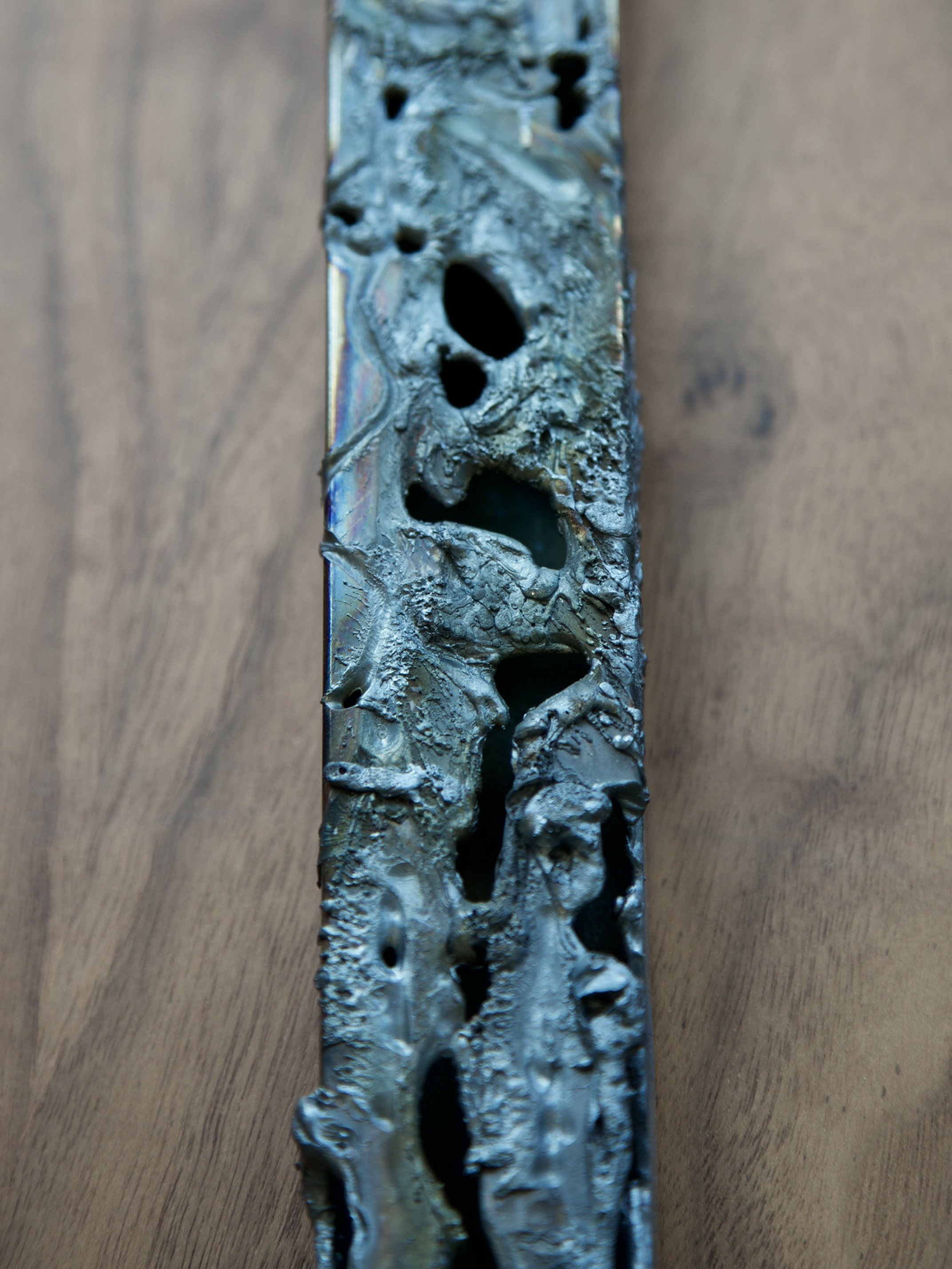 Detail of the corroded, perforated surface of the chrome steel electrode